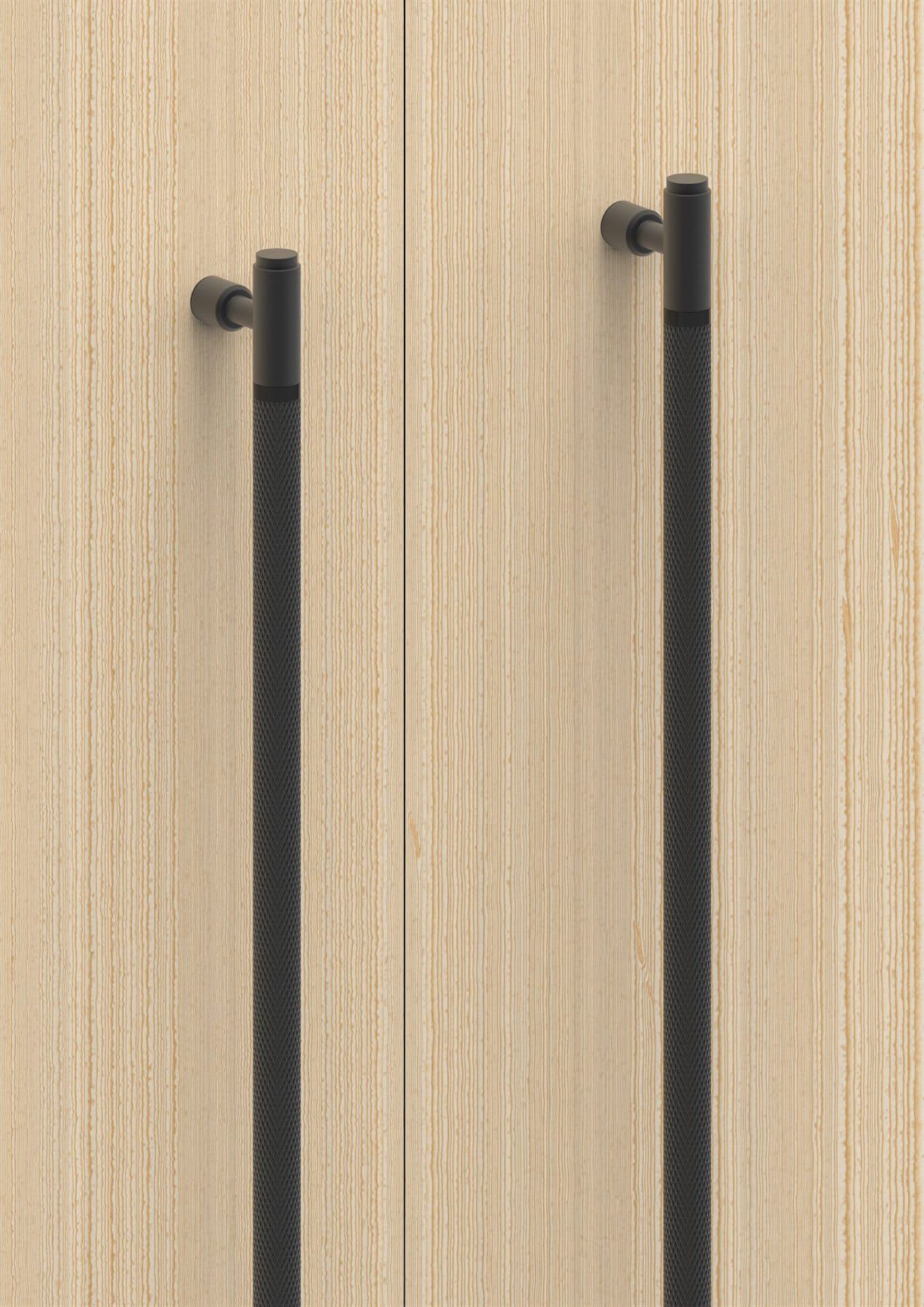 Knurled long pulls in Graphite Black on light oak doors