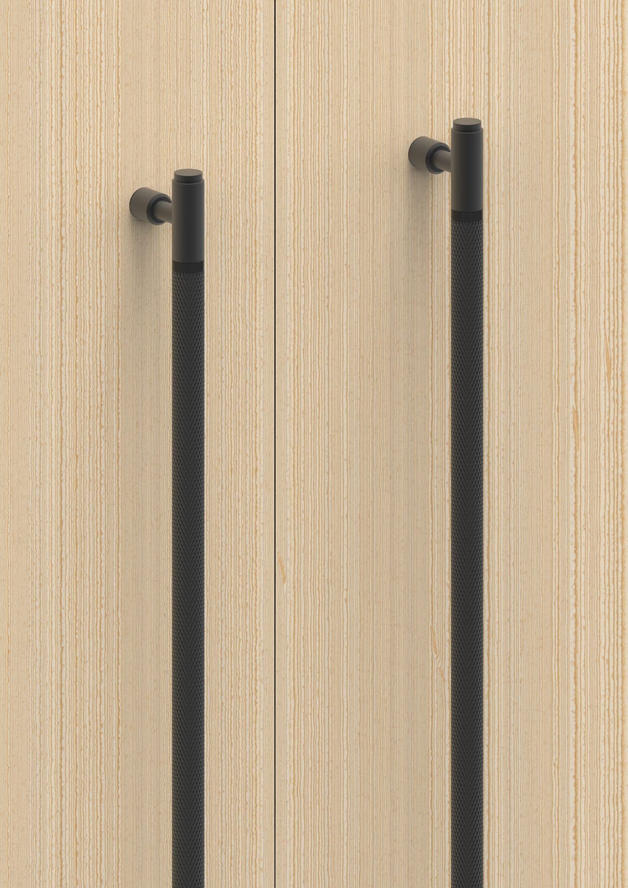 Madhuram architectural door handles in matte black on light wood doors